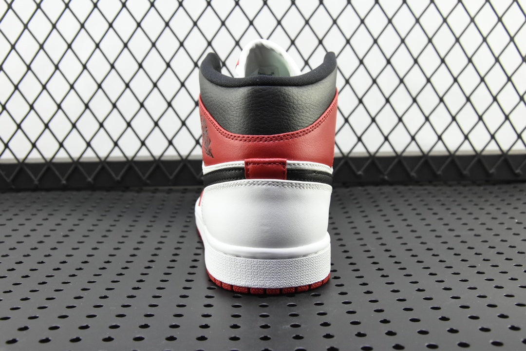 Mid-top sneaker heel view with red collar and white midsole