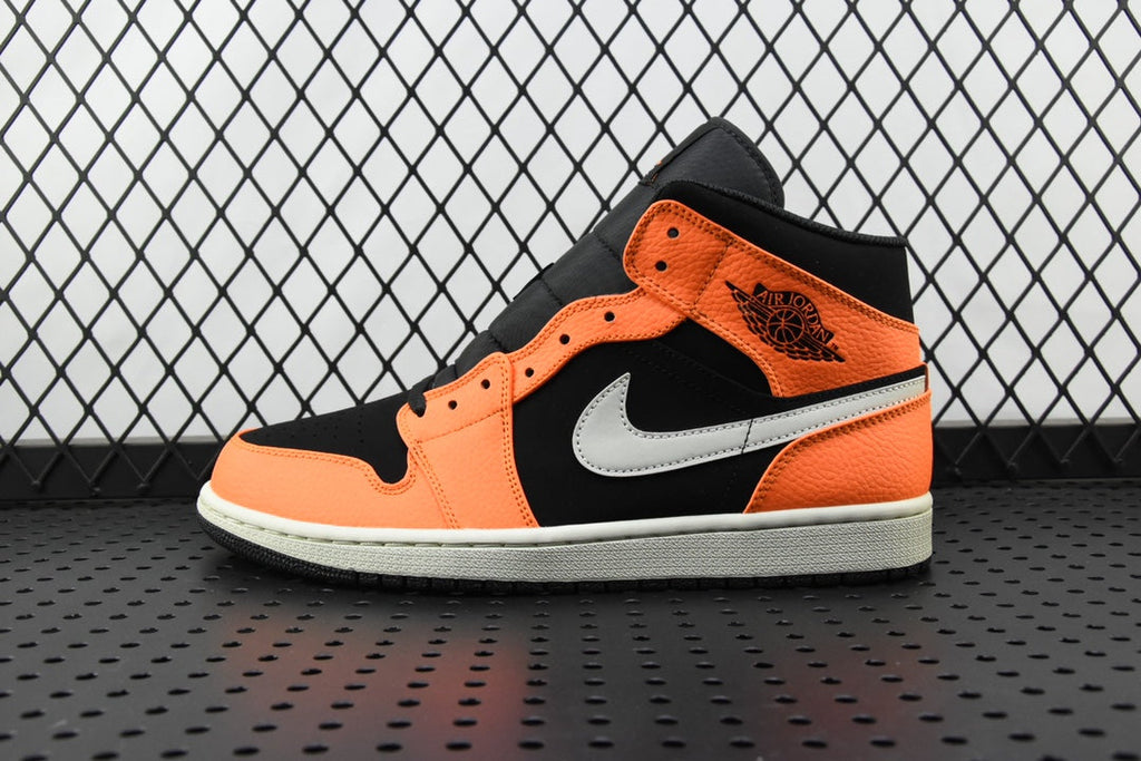 Mid-top sneakers in orange, black, and white with black collar and white swoosh