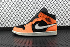 Mid-top sneakers in orange, black, and white with black collar and white swoosh
