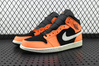 Mid-top sneakers angled view with orange panels, black overlays, and white midsole