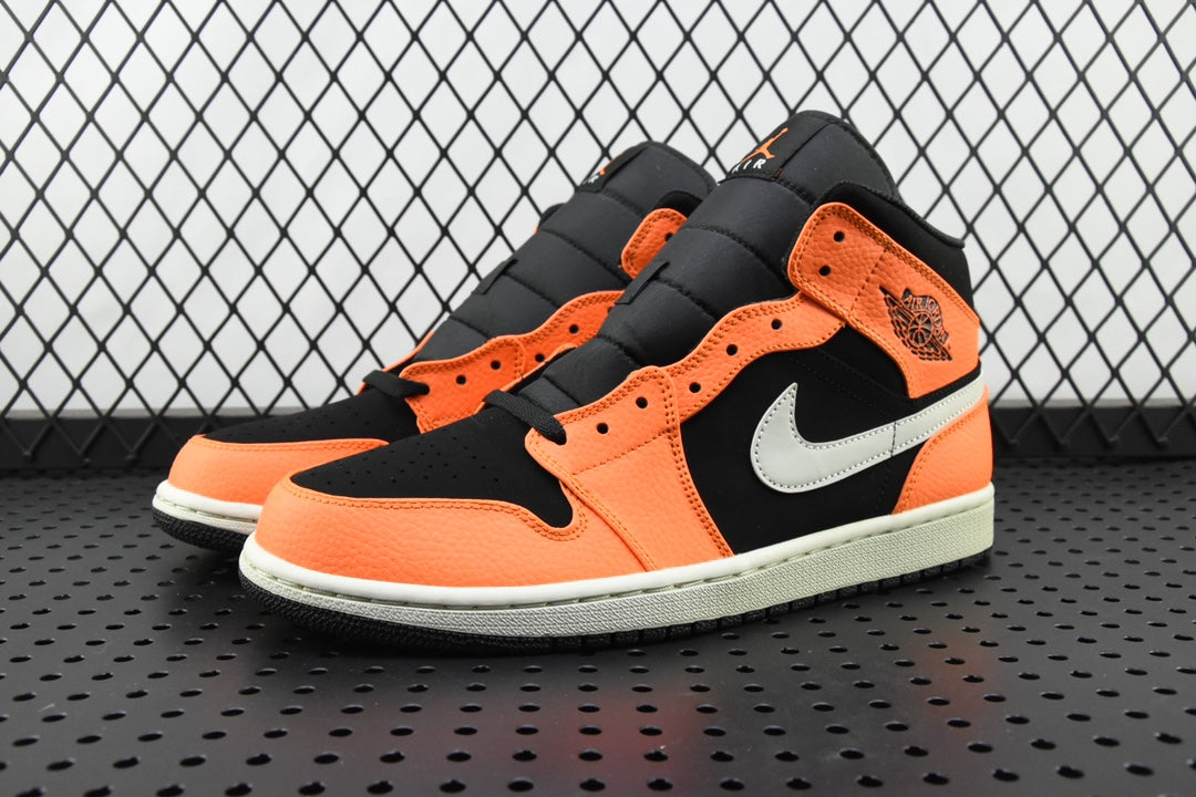 Mid-top sneakers angled view with orange panels, black overlays, and white midsole