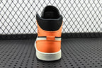 Back view of mid-top sneakers with orange heel panel, black collar, and white sole