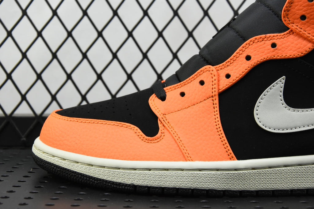 Close-up of side panel with orange leather, black trim, and a white swoosh