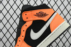 Front quarter view of mid-top sneakers with black upper, orange accents, and white swoosh