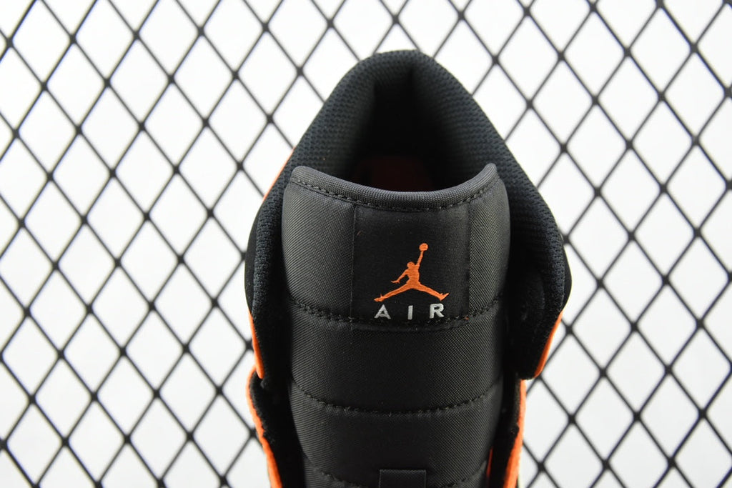 Heel view of mid-top sneaker with black leather and orange AIR branding
