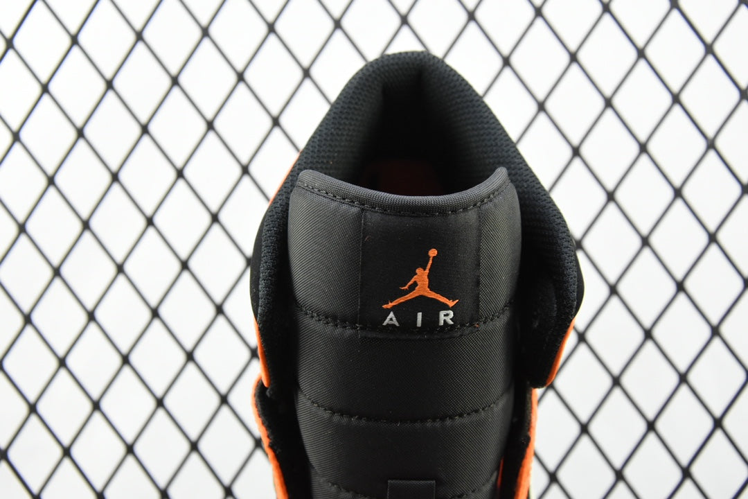 Heel view of mid-top sneaker with black leather and orange AIR branding