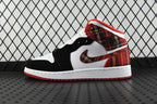 Mid-top sneakers with white and black panels, red plaid collar, and red outsole