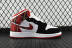 Mid-top sneakers with white leather panels, black overlays, and red plaid collar detail