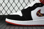 Black and white mid-top sneakers with stitched swoosh and red plaid collar detail