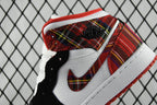 Mid-top sneakers close-up: red plaid heel collar with black swoosh on white leather