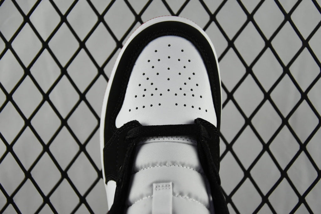 White perforated toe box with black laces on mid-top sneakers