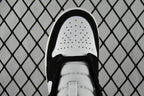 White perforated toe box with black laces on mid-top sneakers