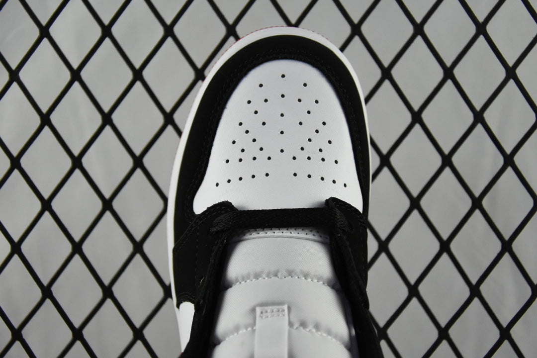 White perforated toe box with black laces on mid-top sneakers