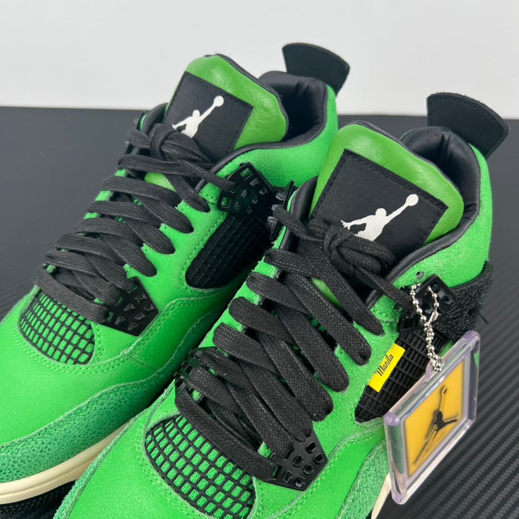 Air Jordan 4 sneaker close-up with black laces, green panels, and heel patch