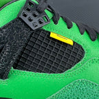 Neon green sneaker with black textured mudguard and yellow branding stripe