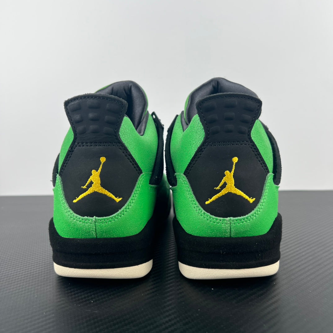 Pair of Air Jordan 4 sneakers from heel showing black back panels and green uppers