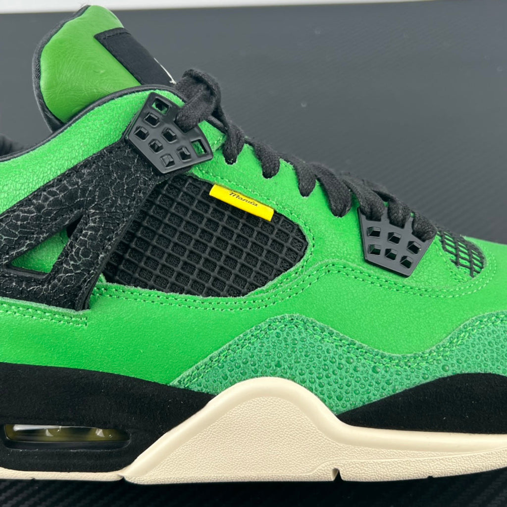 Air Jordan 4 sneaker close-up of toe and quarter panel with black mesh overlay