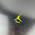 Neon yellow Jumpman logo and Manila text on gray fabric patch