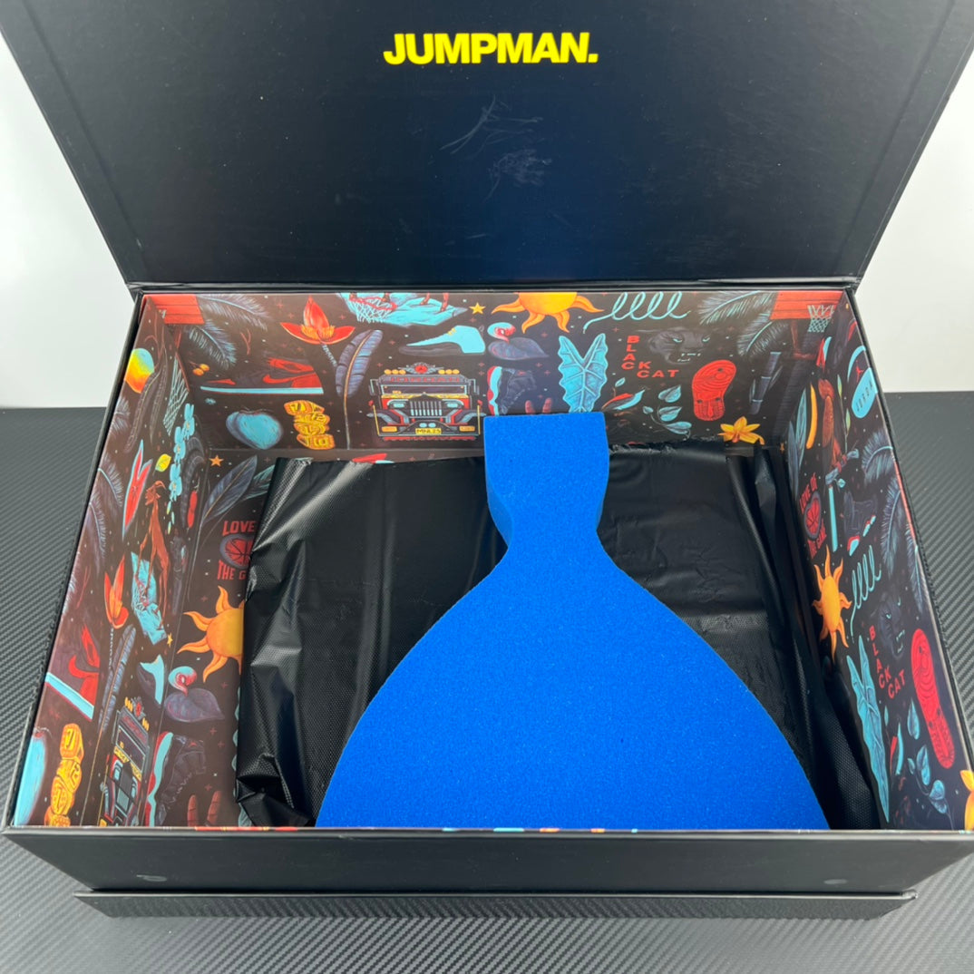 Air Jordan 4 sneaker box open with blue insert and black protective wrap