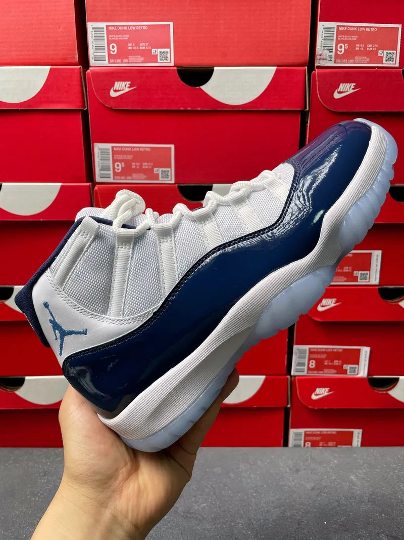 Air Jordan 11 sneakers, white and navy with white laces and textured outsole