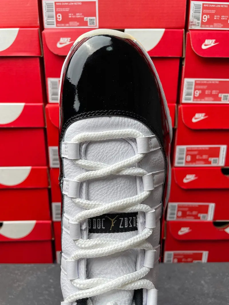 White Air Jordan 11 high-top sneaker with white laces, top of tongue detail