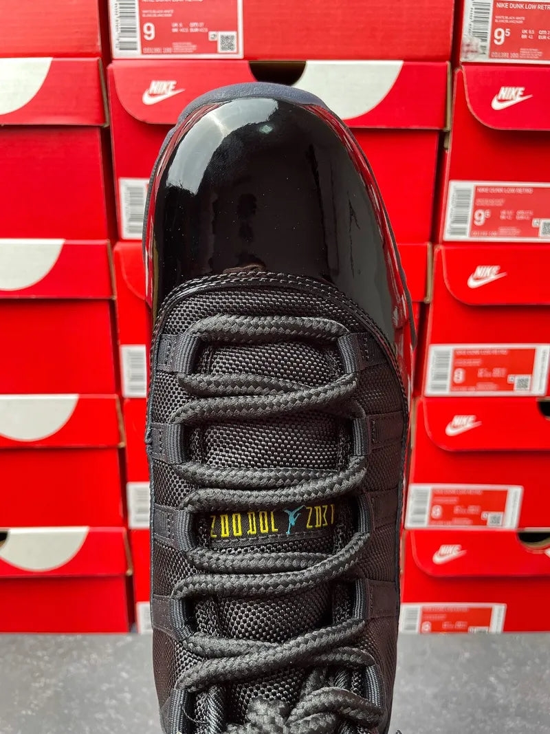 Black sneaker toe view with lace loops and patterned mesh upper