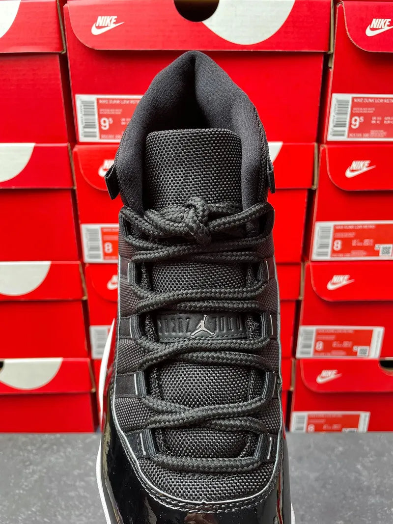 Black sneaker tongue and lace area with woven texture and strap buckles