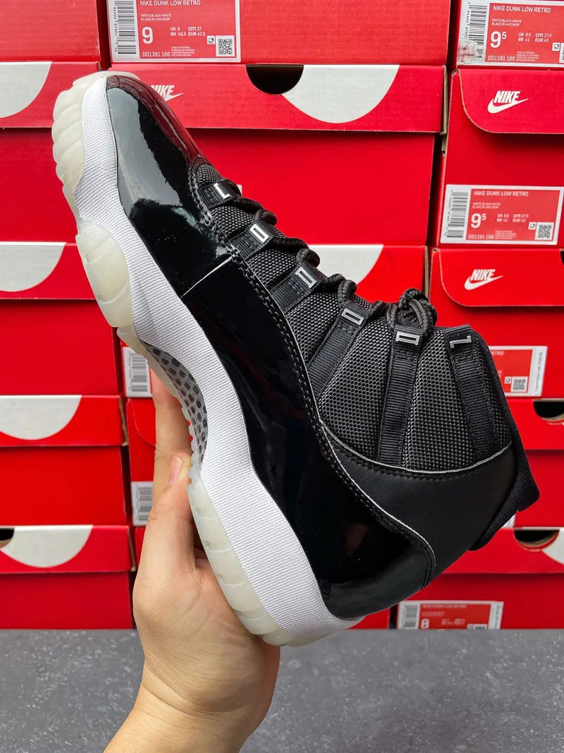 Black high-top sneaker with glossy red side trim and white traction outsole