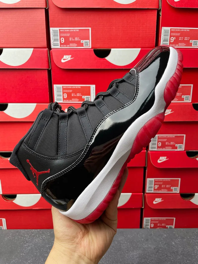 Black high-top sneaker with red outsole, white midsole, and lace-up front panel