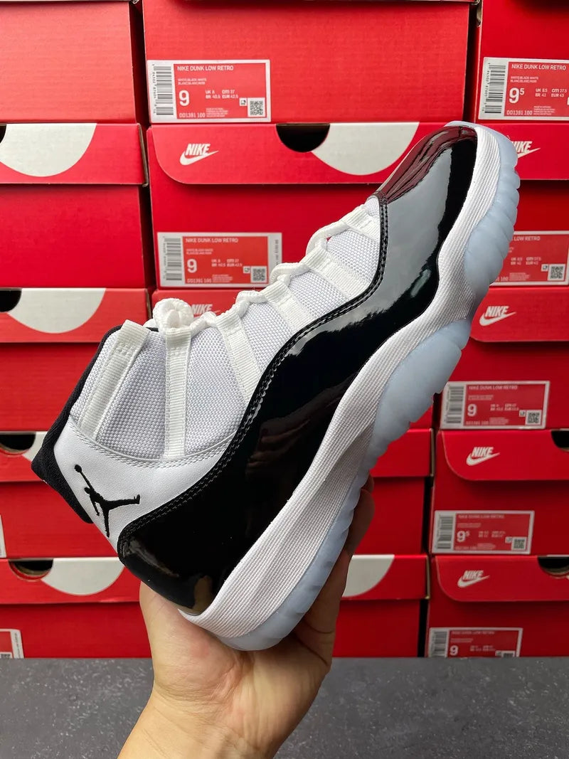 Air Jordan 11 sneakers, white mesh with black patent quarter panel and midsole