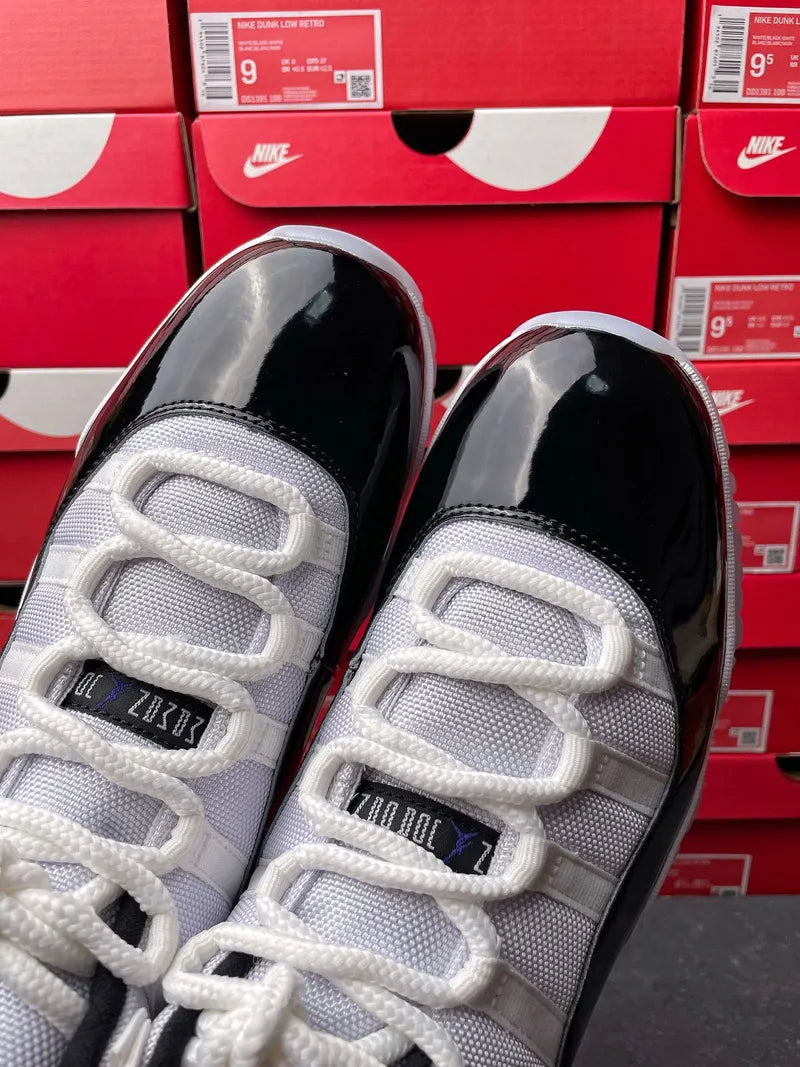 Air Jordan 11 sneakers, close-up of white laces and mesh tongue with black interior