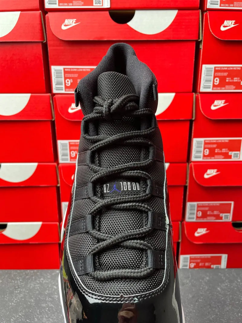 Black high-top sneaker top view with lace knots, padded tongue, and gray outsole