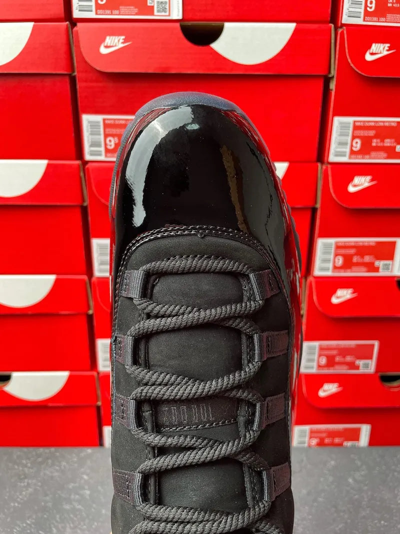Air Jordan 11 sneaker top view, black leather with woven lace panels