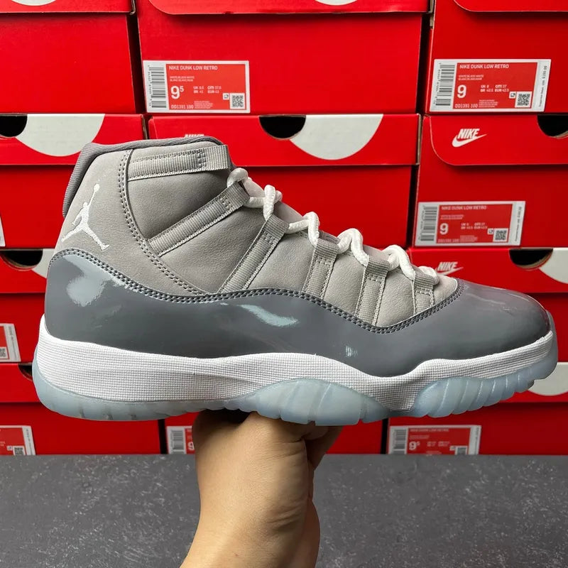 High-top Air Jordan 11 sneakers in cool grey with white laces and translucent sole