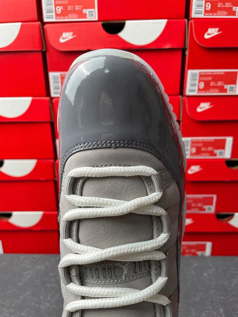 Cool grey high-top sneaker front view with white laces and stitched eyelets