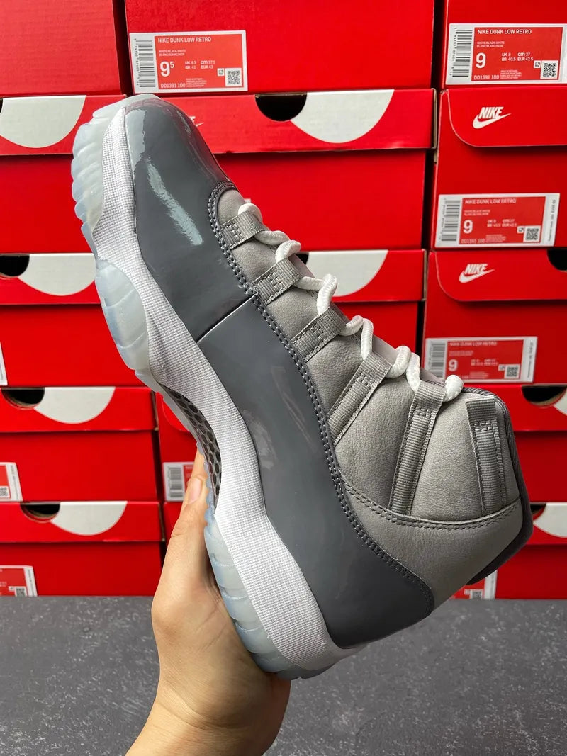 Cool grey Air Jordan 11 sneaker front-side angle with white laces and thick sole