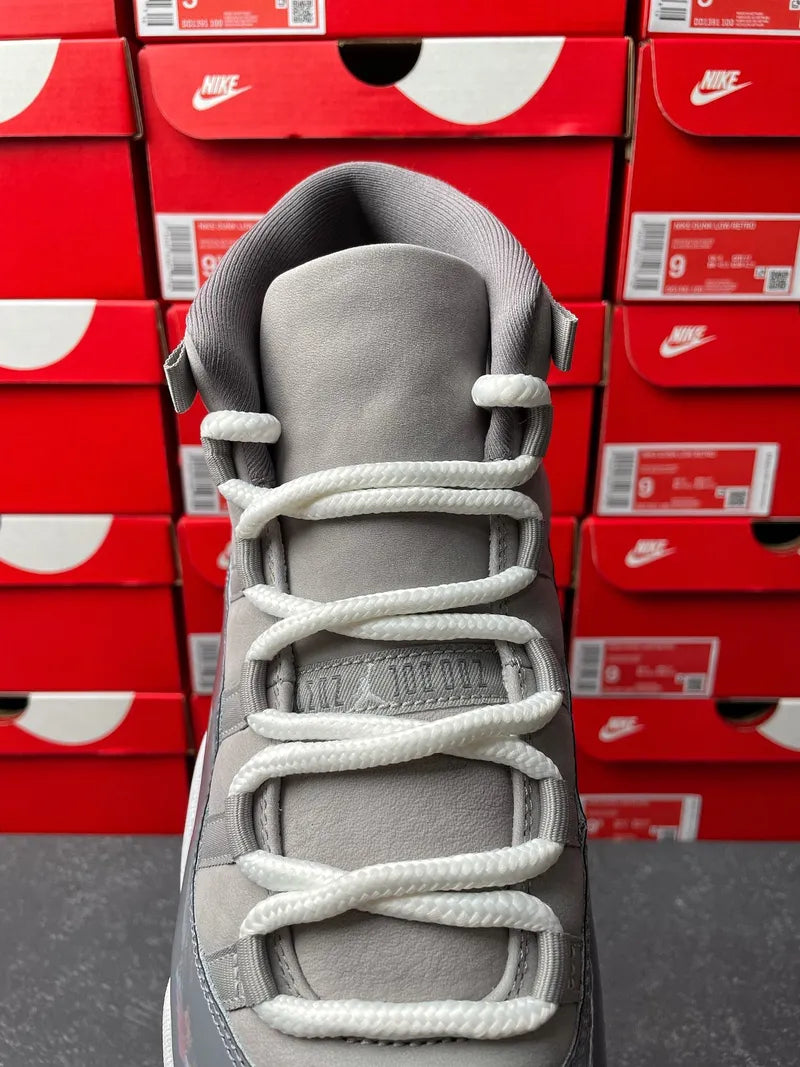 Cool grey high-top sneaker top view with white rope laces and padded ankle cuff
