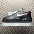 Black low-top Air sneaker with white swoosh, orange tag, and "AIR" heel logo