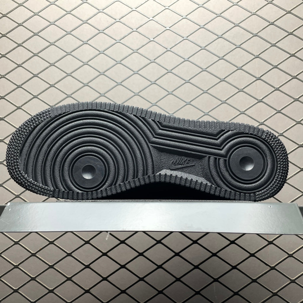 Black rubber outsole with circular traction pattern and textured tread