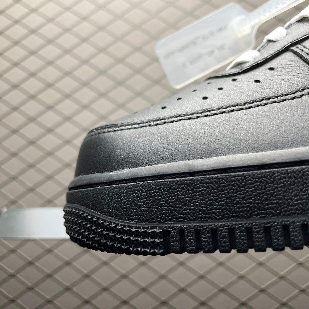 Black sneaker side view with perforations and chunky textured sole edge