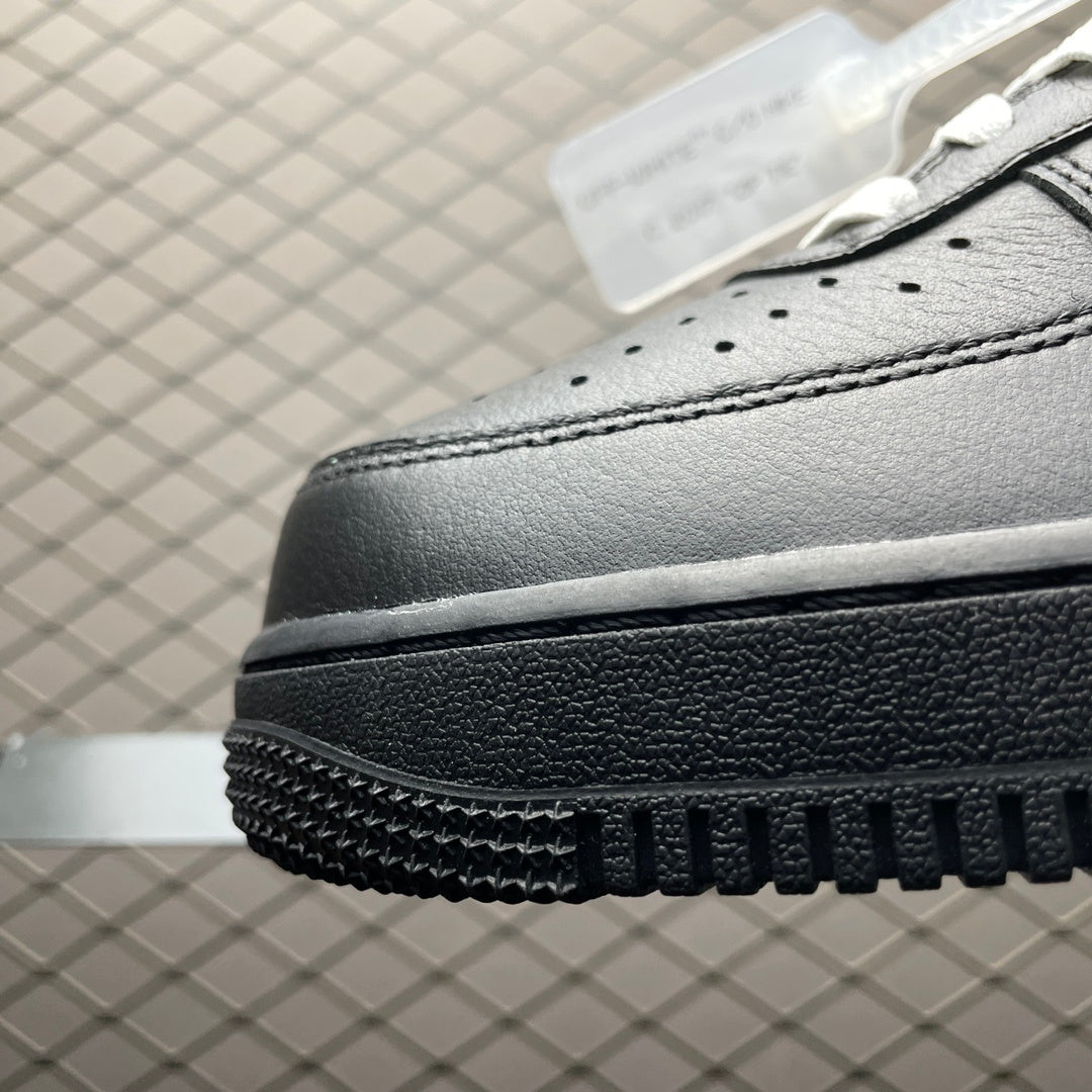 Black sneaker side view with perforations and chunky textured sole edge