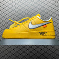 Yellow low-top sneakers with large Swoosh and “AIR” logo on the side