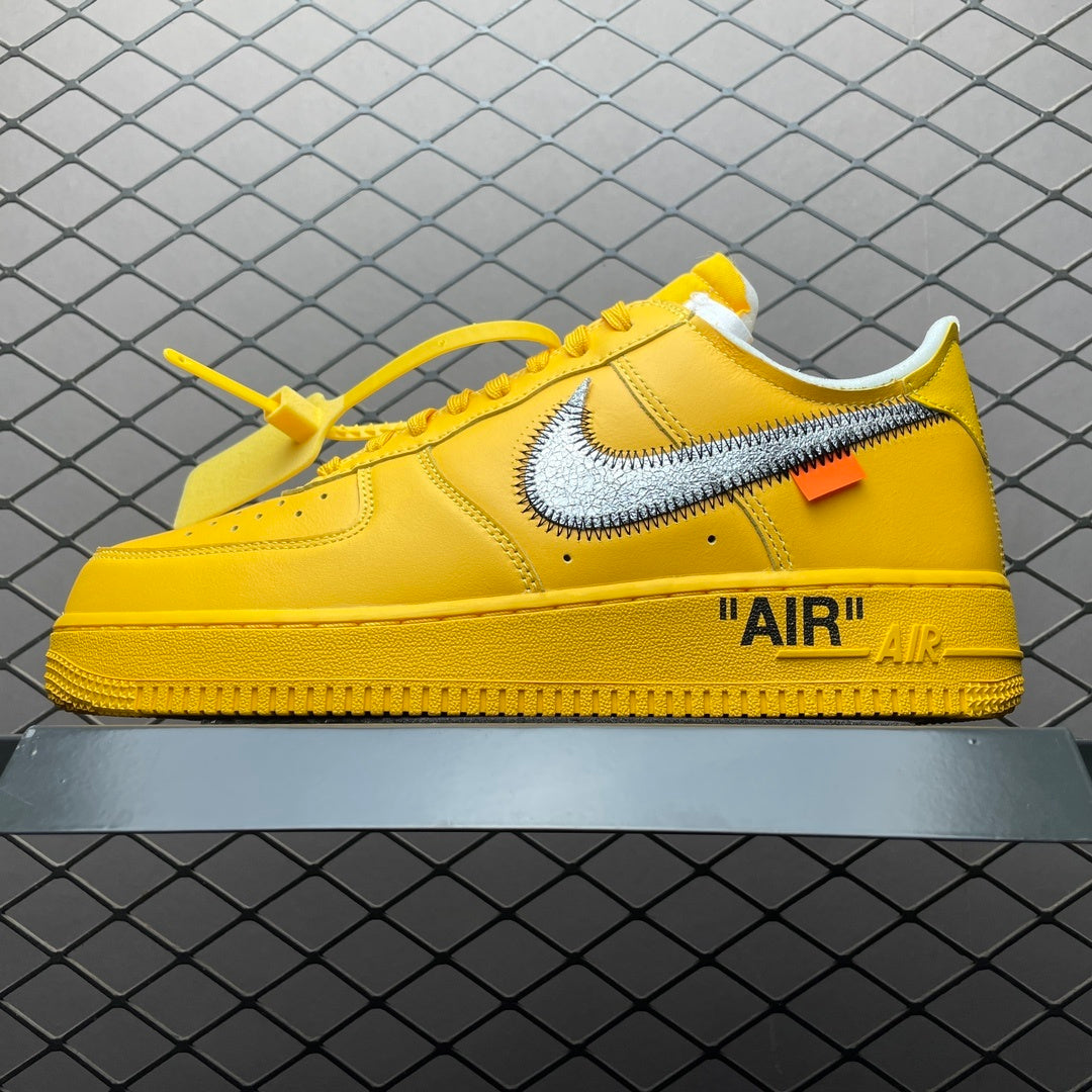 Yellow low-top sneakers with large Swoosh and “AIR” logo on the side