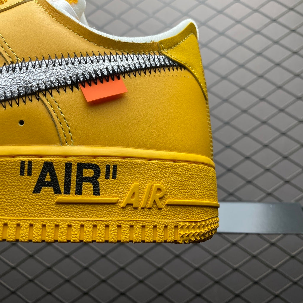 Close-up of yellow sneaker side with Swoosh stitching and “AIR AIR” text