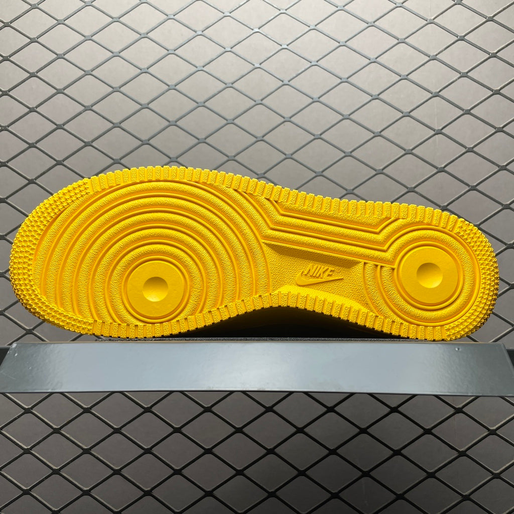 Yellow sneaker outsole with circular traction patterns and Nike logo