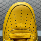 Yellow sneaker toe panel with perforations and stitched eyestay detail