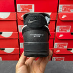 Black Air Force 1 sneaker heel view with logo patch and black outsole