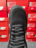 Black sneaker toe and lace-up front view, textured mesh upper