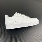 White low-top sneakers with stitched swoosh and lace-up front