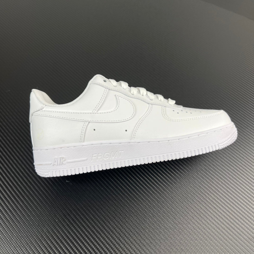 White low-top sneakers with stitched swoosh and lace-up front